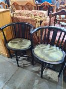 A pair of ebonized style combe back corner chairs