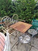 An iron scroll work garden bench, 2 similar chairs and a square table