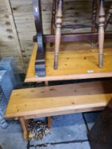 A pine kitchen table with pair of matching benches