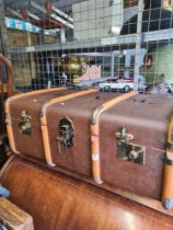 An old canvas trunk, wooden bound with removable tray