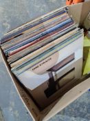 A box of vinyl LPs including many by Dire Straits and a few 7" singles