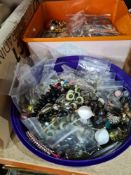 Two small plastic tubs of costume jewellery