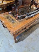 A modern Chinese coffee table, the centre having pierced carved decoration with glass above, 140cm