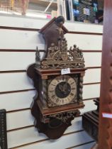 Brass and wood wall clock depicting Atlas at the top centre