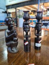 A pair of African carved candlesticks and a similar figure smoking pipe
