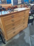 A reproduction oak chest having 2 short and 3 long drawers on plinth base, 122cm