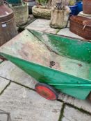 An old cast iron garden roller and a metal rubbish collector