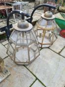 A pair of modern octagonal coach house lamps with wall mounted supports