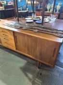 Hugo Troeds, a 1960s teak sideboard having central drawers with sliding cupboard doors purchased fro