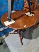 An antique mahogany tripod table having bird cage support on pad fee, 74cm