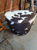 A vintage Ikea revolving stool having cow hide upholstery