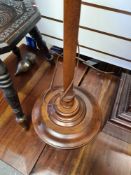 An adjustable wooden standard lamp