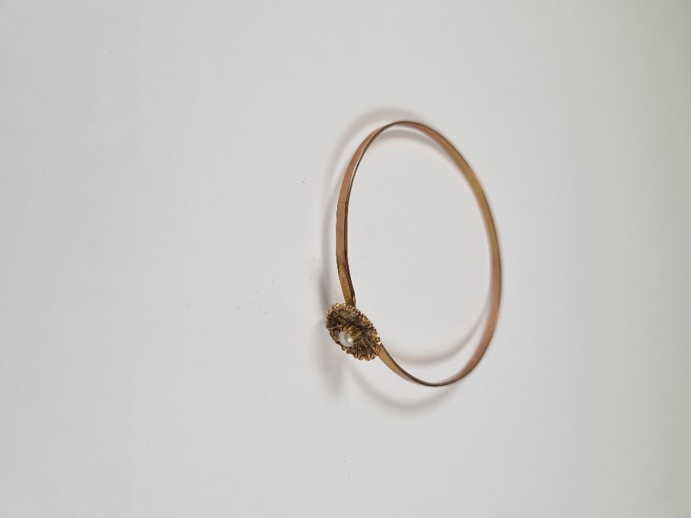 Unmarked yellow gold bangle with hook clasp below flowerhead, inset with seed pearls, 6cm diameter, - Image 14 of 17