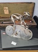 A sculpture by Clare Bigger, of a Cornering Cyclist, in stainless steel, dimensions 26cm (length) x