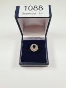 18ct yellow gold sapphire and diamond cluster ring, with central oval sapphire surrounded two steppe