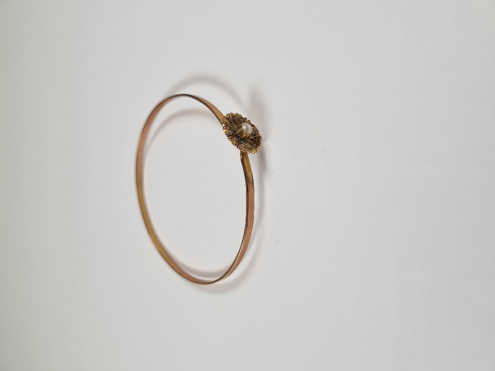 Unmarked yellow gold bangle with hook clasp below flowerhead, inset with seed pearls, 6cm diameter, - Image 3 of 17