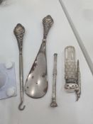 A silver handled shoe horn, and button hook, with embossed handle. Also with silver lidded cut glass