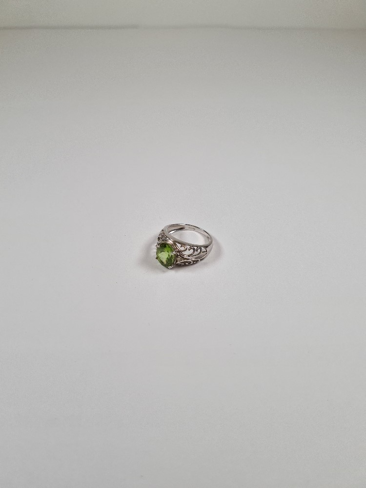 9ct white gold dress ring with oval mixed cut Peridot, each side set small diamond chips, on scrolli - Image 8 of 35