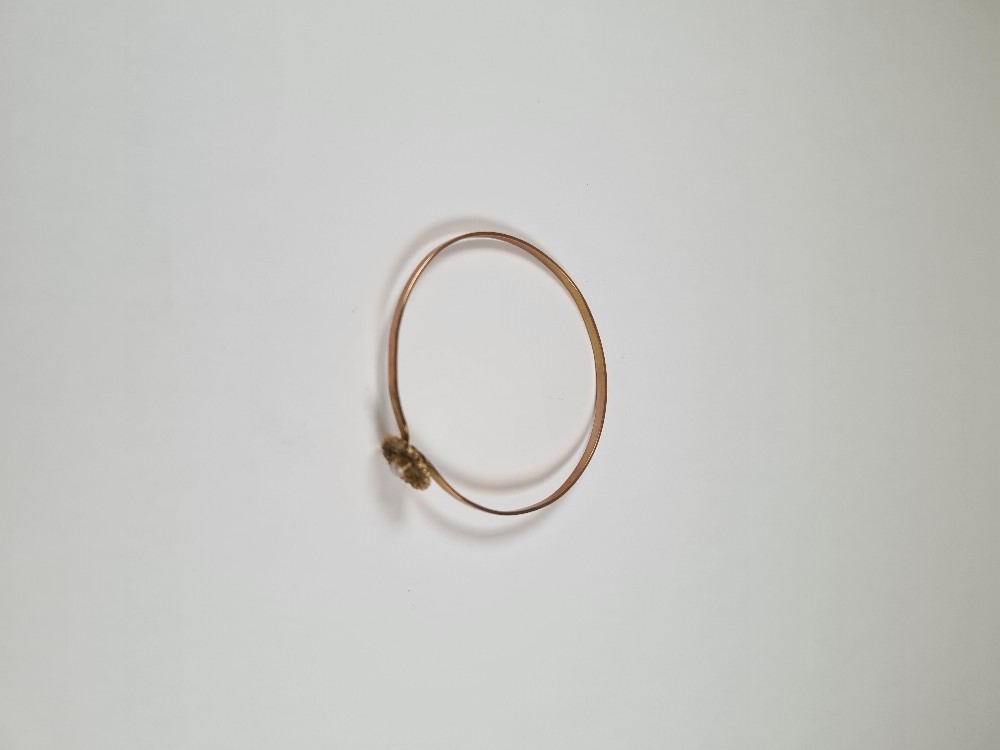 Unmarked yellow gold bangle with hook clasp below flowerhead, inset with seed pearls, 6cm diameter, - Image 17 of 17