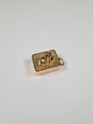 14K yellow gold cased musical pendant, of rectangular form, with bow and horseshoe decoration and ap