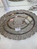 A white metal decorative tray having floral bordered pattern central motif enscribed 'Malaysia' and
