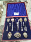 An early 20th century silver set of 6 teaspoons with tong and sifter