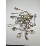 A quantity of silver spoons and white metal, approx 6.35 ozt, having decorative designs, souvenir st