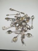 A quantity of silver spoons and white metal, approx 6.35 ozt, having decorative designs, souvenir st