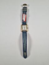 Cartier; A 18K gold plated Cartier wristwatch white dial and Roman numerals, on blue leather strap