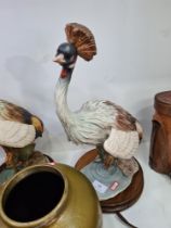 A pair of Capodimonte figures of African crested Cranes signed Guiseppe Armanion circular wooden bas