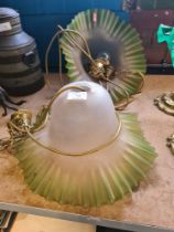 A pair of frosted glass ceiling lights having green crimped rim
