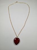 9ct yellow gold neckchain hung with a large heart shaped pendant, possibly amber - chain marked 9ct,