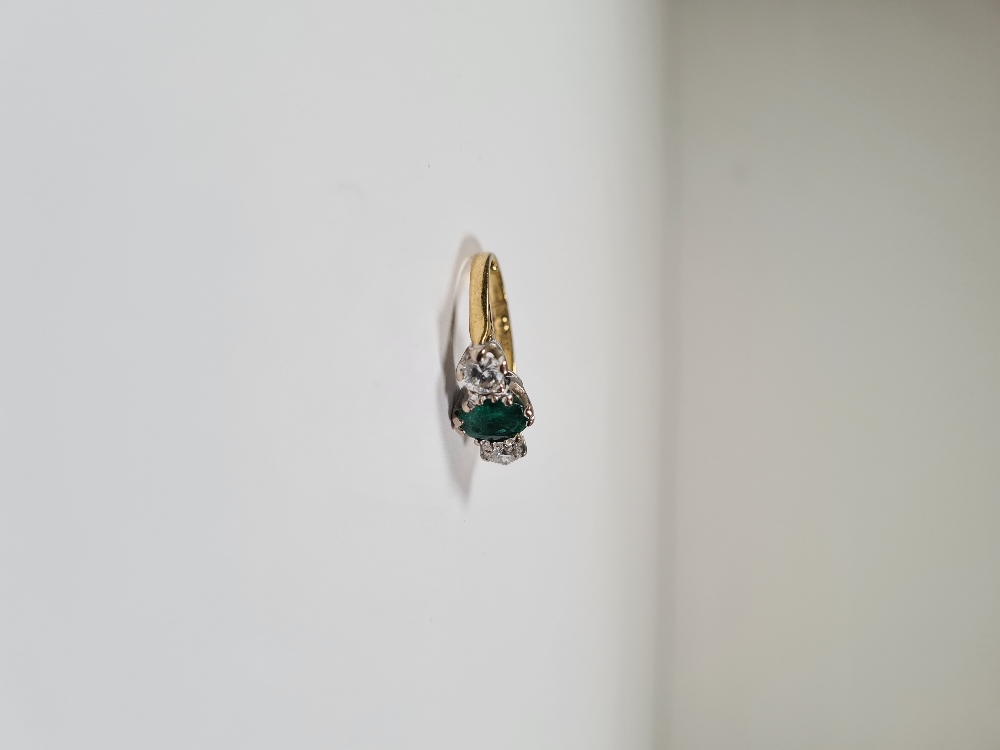 18ct yellow gold emerald and diamond trilogy ring, with central oval mixed cut emerald with a brilli