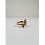 18ct yellow gold dress ring in the form of 2 crossing Snake's heads, Channel set with square cut rub