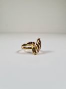 18ct yellow gold dress ring in the form of 2 crossing Snake's heads, Channel set with square cut rub