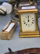 A miniature brass carriage clock 8cm, and a Victorian silver and Mother of Pearl penknife