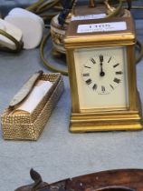 A miniature brass carriage clock 8cm, and a Victorian silver and Mother of Pearl penknife