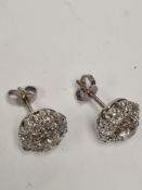 Pair of white metal diamond cluster earrings with central old round cut diamond, approx 0.5 carat su