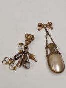 Antique 9ct gold bow form brooch hung with a vintage gilt metal mounted Mother of Pearl bodied perfu