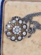 Victorian silver and gold diamond set openwork pendant/brooch of daisy head design, central rubover