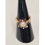 Unusual 18ct and platinum dress ring, with central pearl surrounded square cut rubies, size L, appro