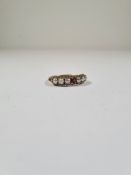 9ct yellow gold dress ring, with central garnet each side flanked 3 seed half pearls, size R/S, mark