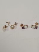 Pair of 10K yellow gold stud earrings each with round cut amethyst above heart shaped white opal and