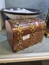 A Victorian burr walnut domed top tea caddy having gilt metal decoration, 20cm