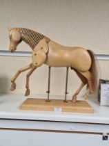 A modern wooden Artist's lay figure of a horse on oblong base, 51cm