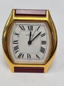 Cartier; A vintage Cartier travel clock, with rounded rectangular white dial with Roman Numerals in