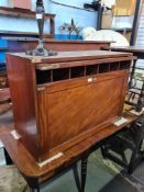 An antique mahogany stationary cabinet having full front enclosing shelves and drawers, 91.5cm