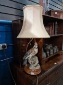 A 1980s table lamp decorated bird on turned mahogany base