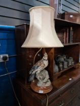 A 1980s table lamp decorated bird on turned mahogany base