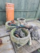 A selection of garden planters, cast iron door stops, hand tools and a chimney pot